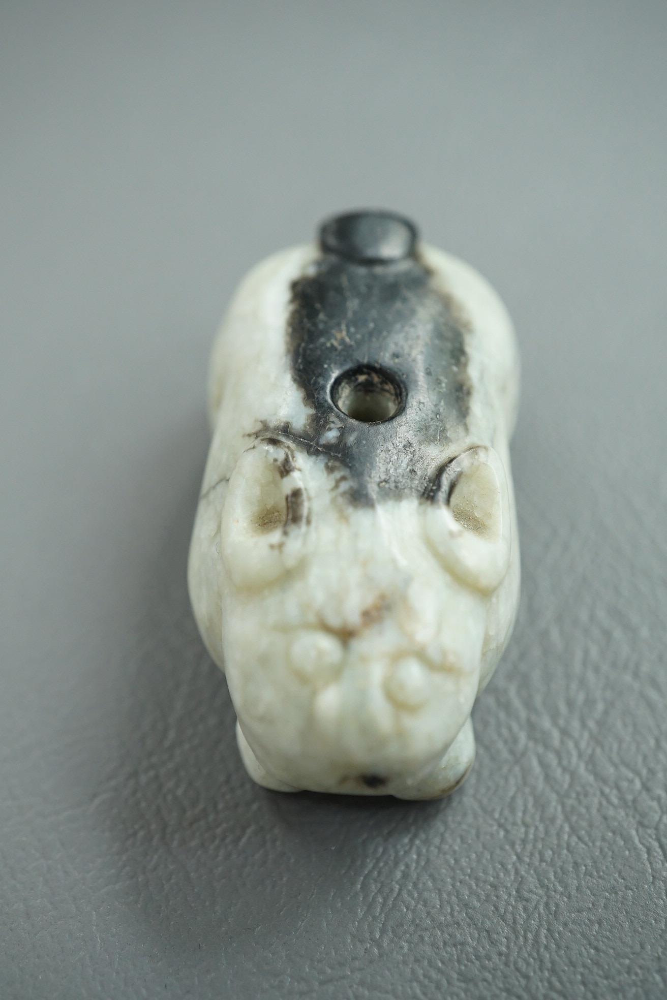 A Chinese white and black jade figure of a recumbent tiger, Song dynasty